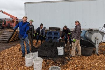 Youth putting feedstock into buckets